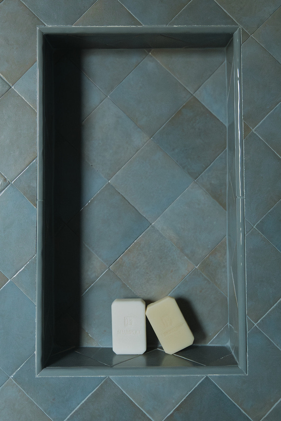 Hyaluronic+ Solid Conditioner Bar displayed on a blue tiled shelf, highlighting plastic free hair care benefits.