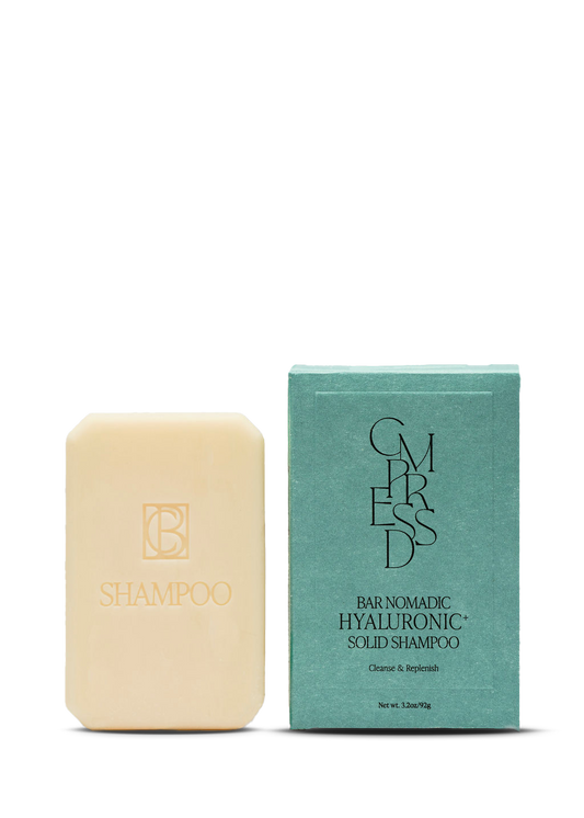 Hyaluronic+ Solid Shampoo Bar by Cmpressd Beauty, a plastic-free solid hair care bar for all hair types. Bar of shampoo and its packaging on a white background