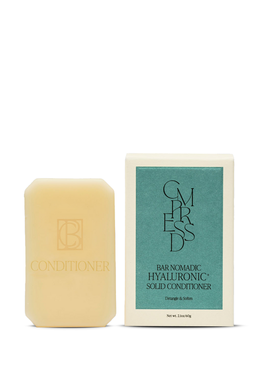 Bar of conditioner with packaging on a white background