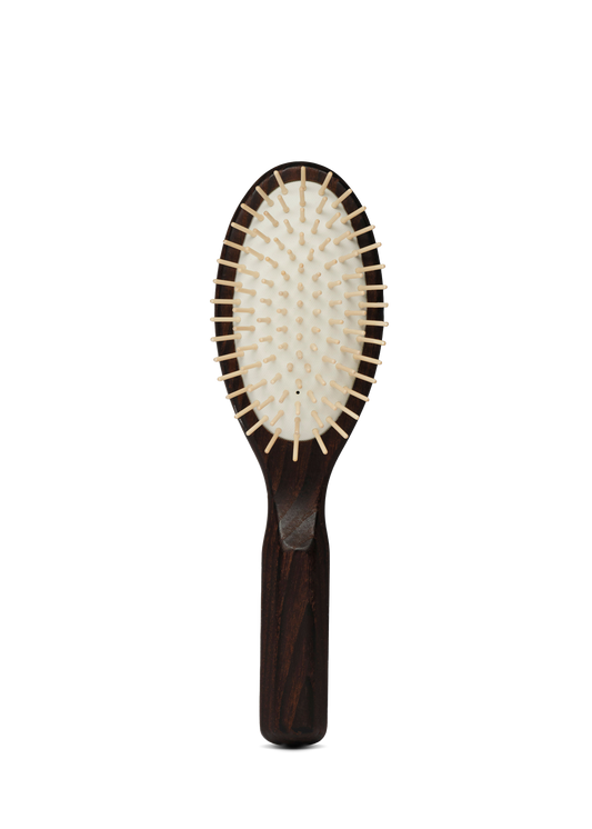 Hairbrush with wooden handle and bristle head on a white background