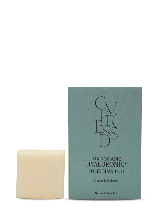Bar of shampoo and its packaging on a white background